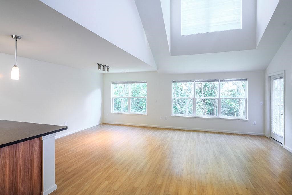 an empty living room with wood floors and a window at Merion Stratford Apartment Homes, Connecticut