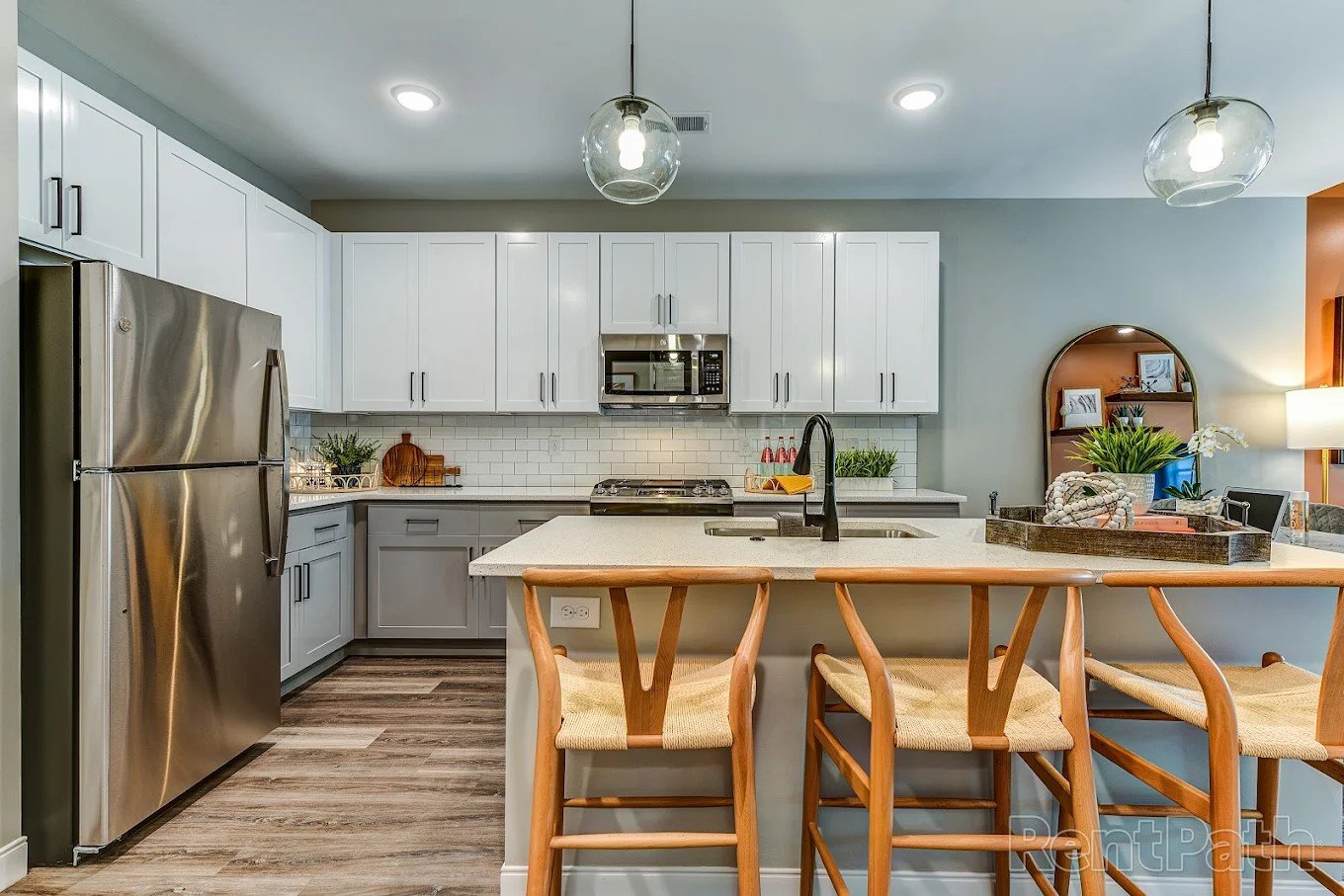 A modern kitchen with a wooden table and chairs.