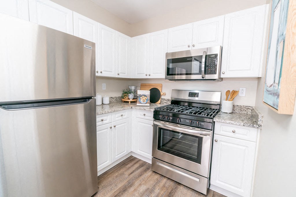 a kitchen with stainless steel appliances and white cabinets at The Ledges Apartment Homes, Groton, CT, 06340