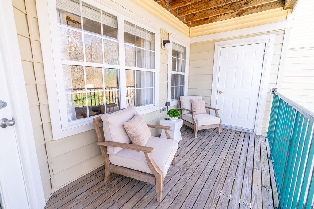 the front porch of a home with two chairs and a table at The Ledges Apartment Homes, Groton, CT, 06340