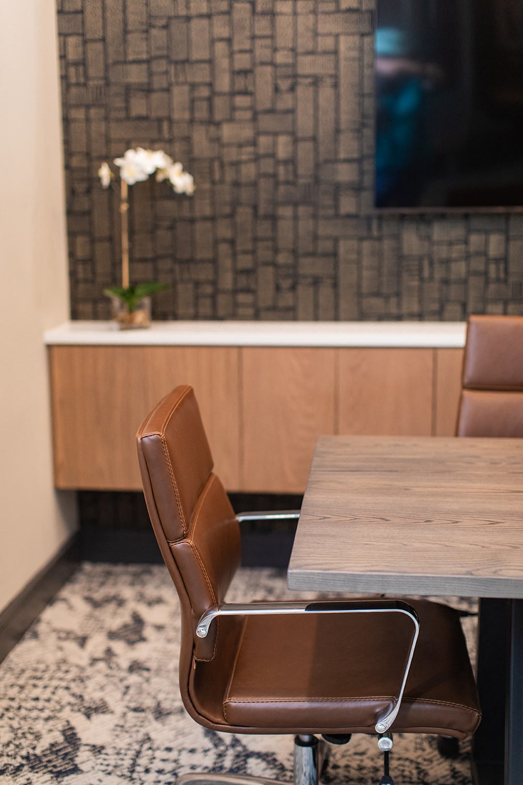 a leather chair sitting next to a wooden table in a room at The Yards at Malvern, Malvern, PA