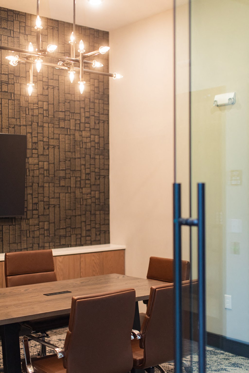 a conference room with a table and chairs and a tv on the wall at The Yards at Malvern, Malvern, PA