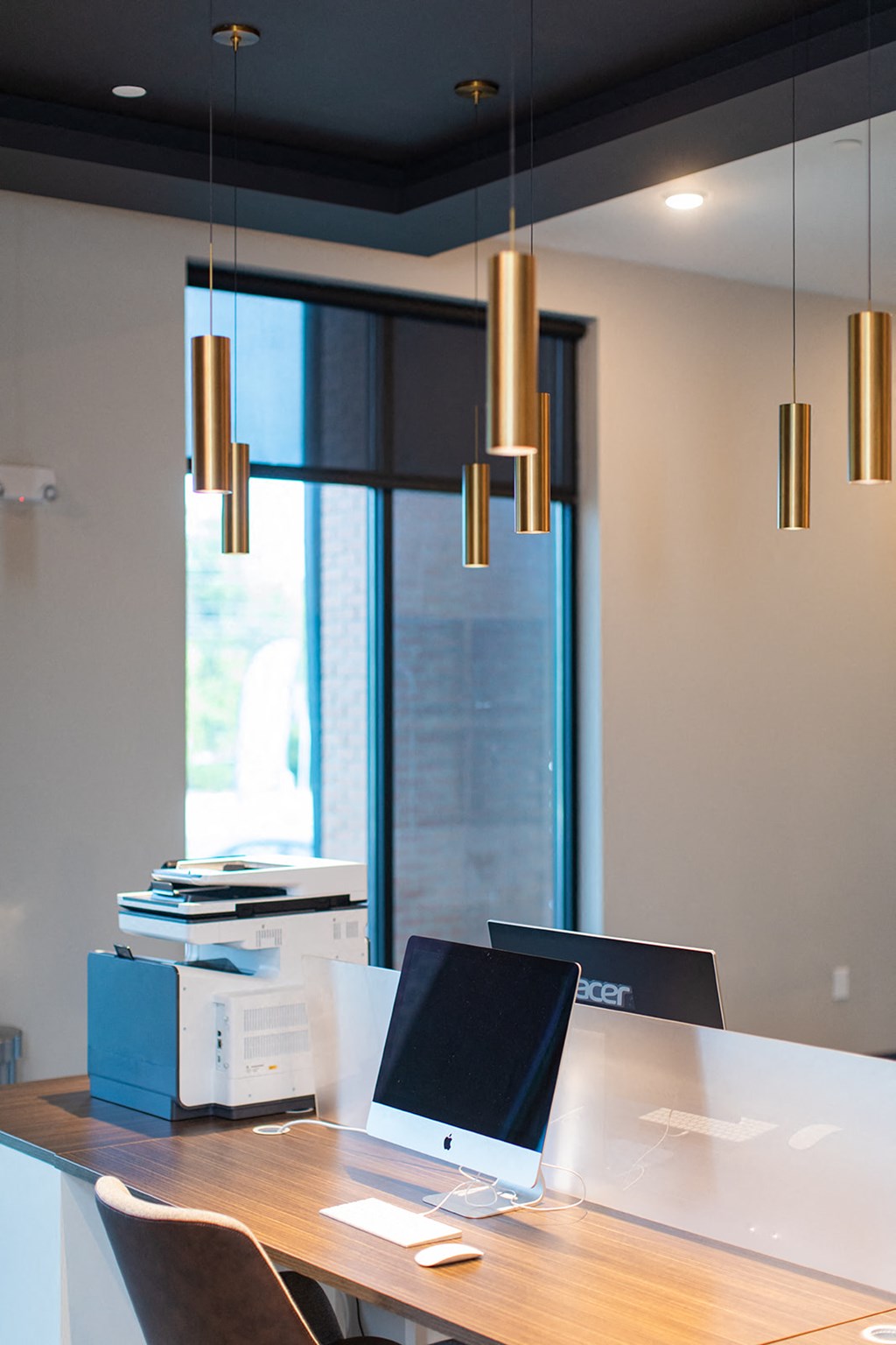 a desk with a laptop and a stack of books at The Yards at Malvern, Malvern, PA