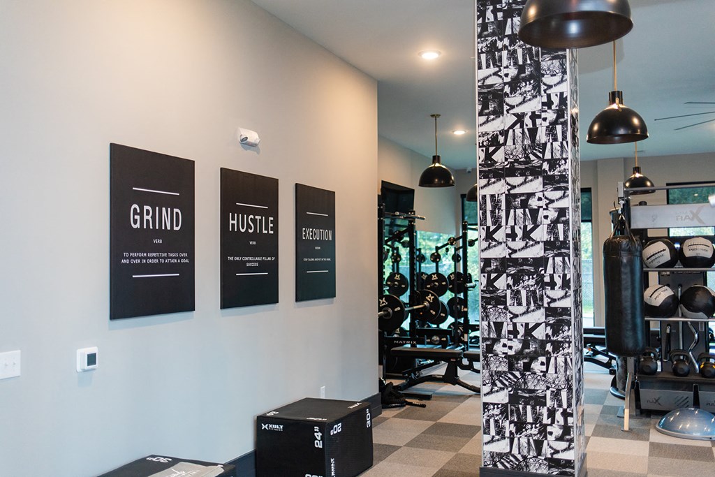 a gym with a variety of machines and posters on the wall at The Yards at Malvern, Malvern, PA