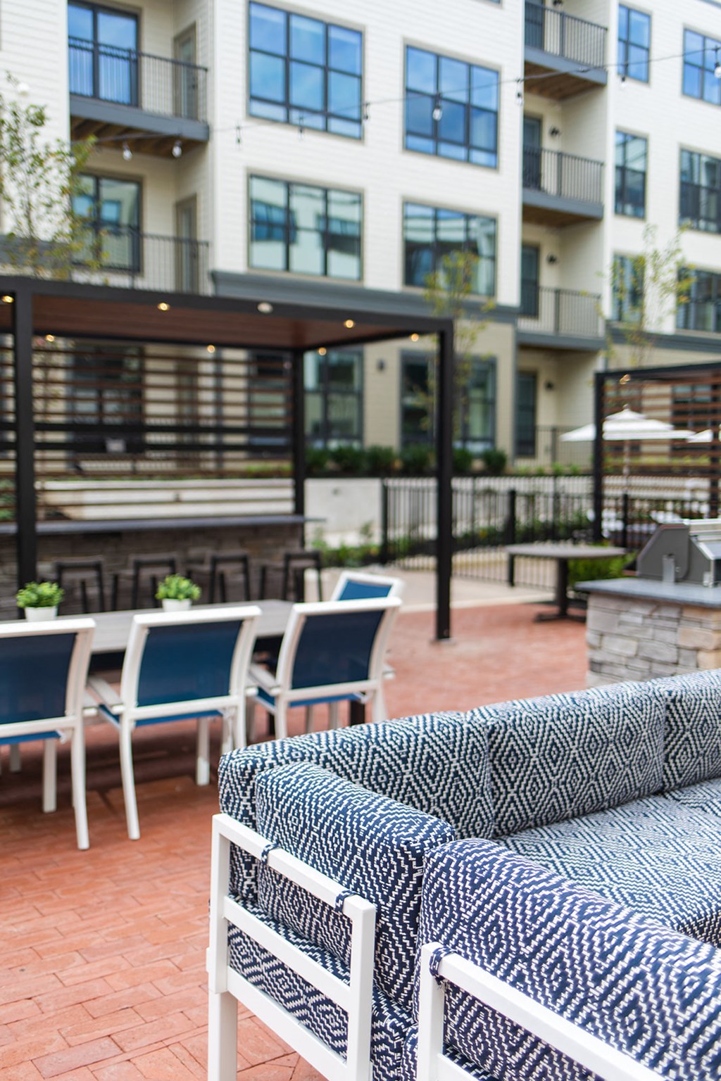 a seating area with chairs and tables in front of a building at The Yards at Malvern, Malvern, PA