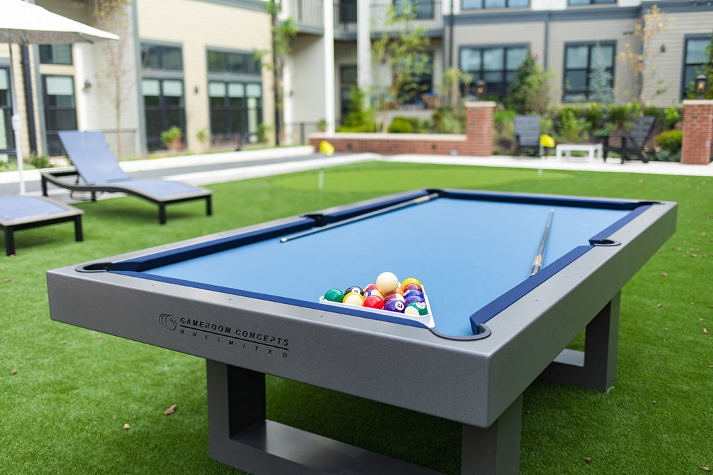 a pool table with balls on top of it in the backyard of a house at The Yards at Malvern, Malvern, PA
