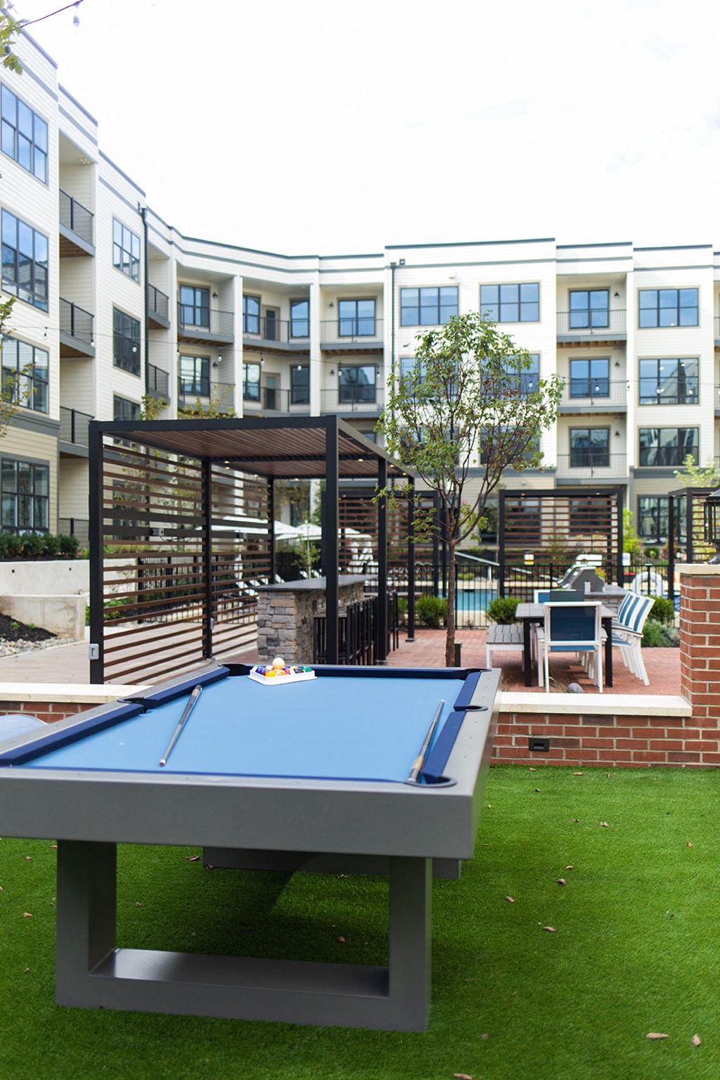 a pool table with an apartment building in the background at The Yards at Malvern, Malvern, PA