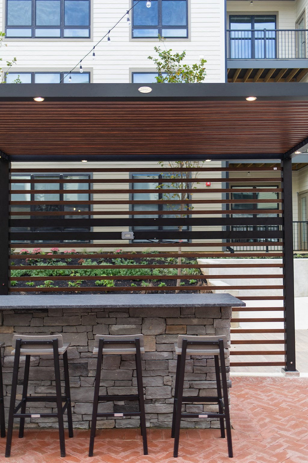 a bar with three stools in front of a house at The Yards at Malvern, Malvern, PA