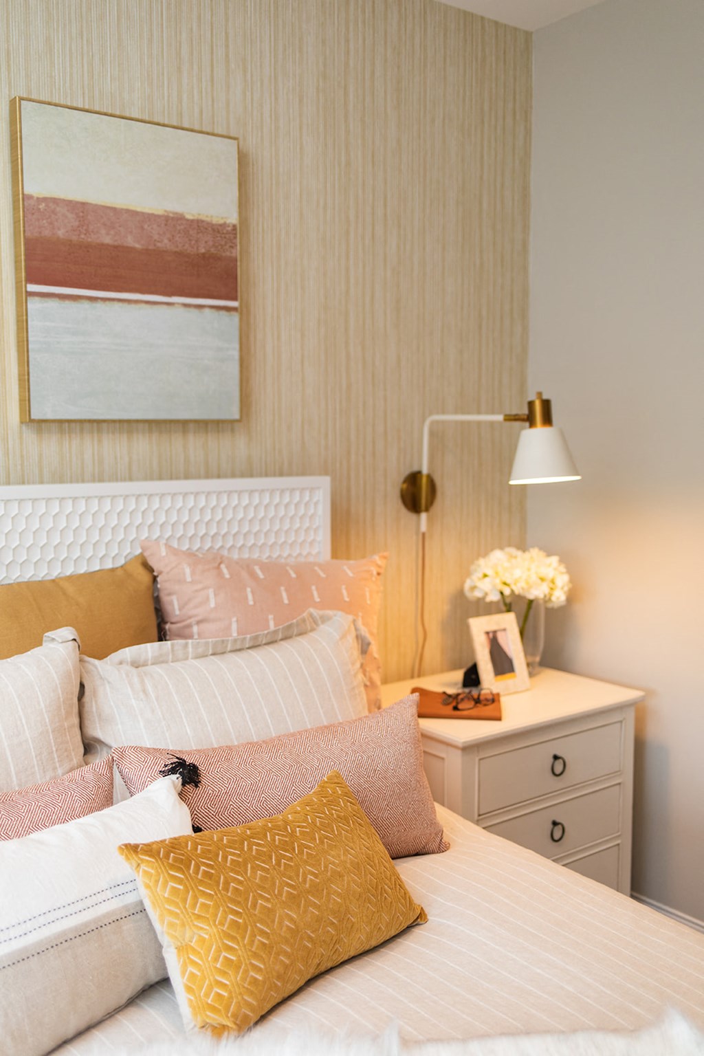 a bedroom with a bed with pillows and a nightstand with a lamp at The Yards at Malvern, Malvern, PA