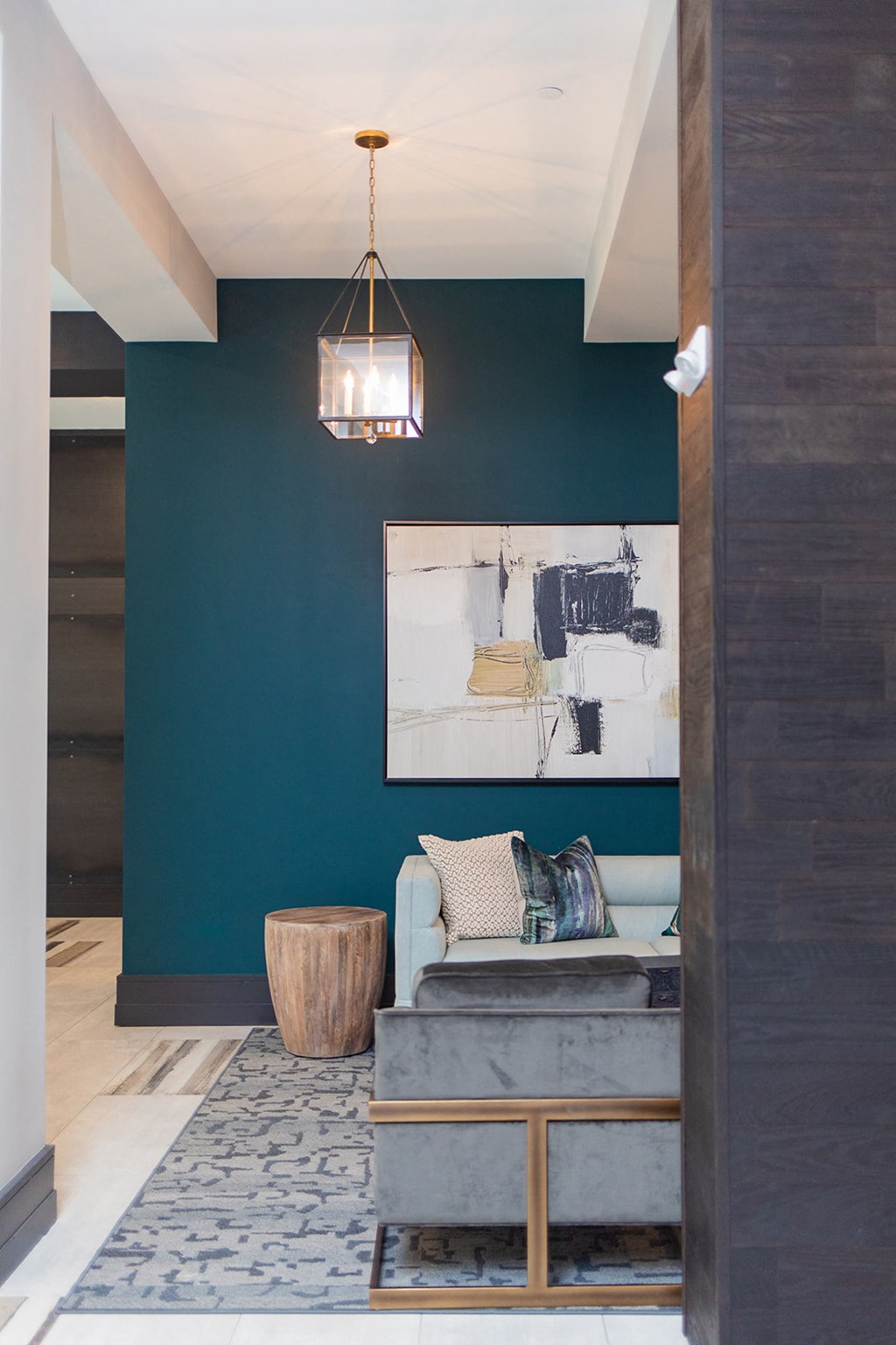 a living room with a blue wall and a couch and a lamp at The Yards at Malvern, Malvern, PA