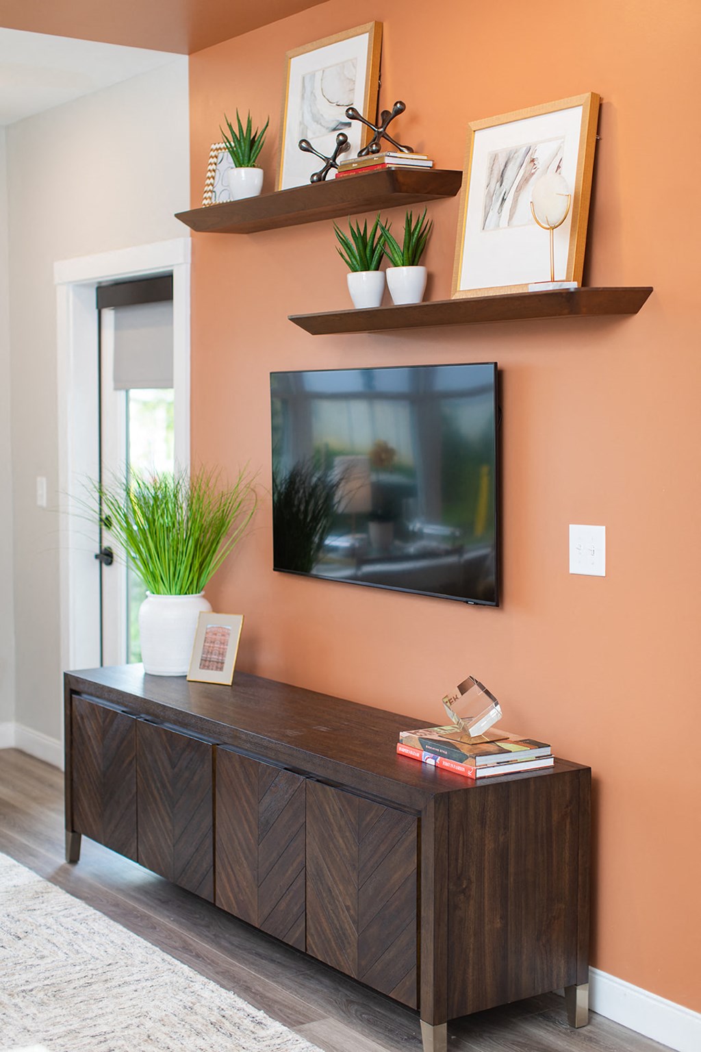 a living room with a tv and shelves on the wall at The Yards at Malvern, Malvern, PA
