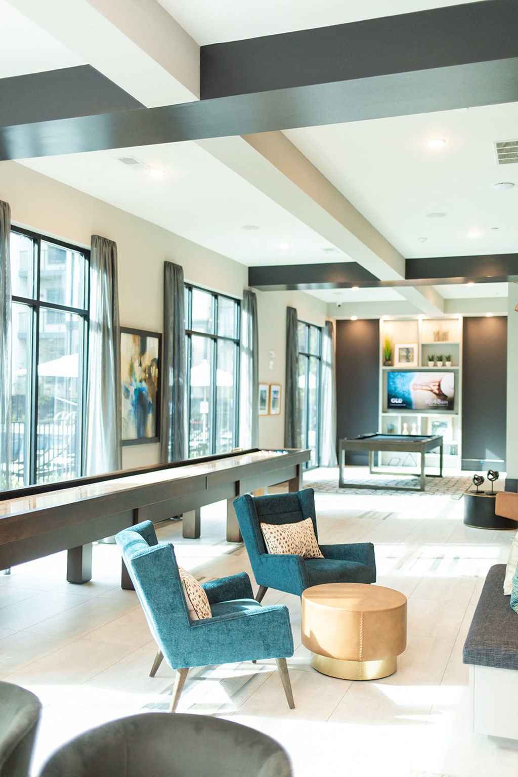 a lobby with blue chairs and a table and windows at The Yards at Malvern, Malvern, PA