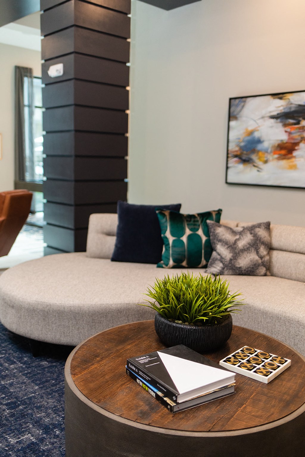 a living room with a couch and a table with books and a plant at The Yards at Malvern, Malvern, PA