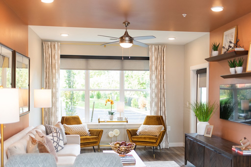 a living room with a large window and a ceiling fan at The Yards at Malvern, Malvern, PA