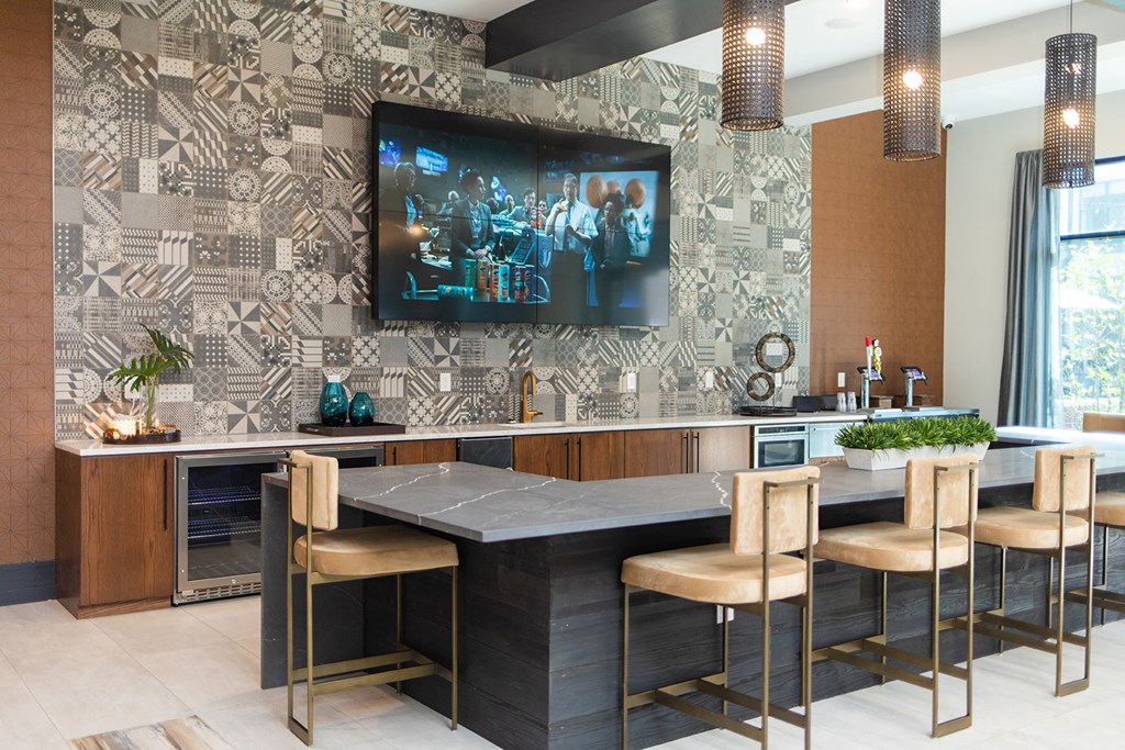 a kitchen with a bar and a tv on the wall at The Yards at Malvern, Malvern, PA