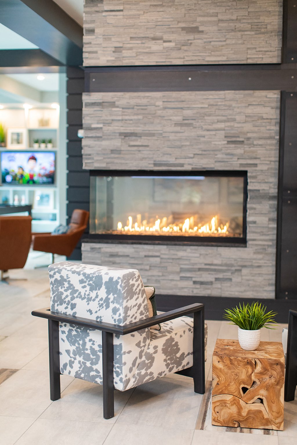 a chair in front of a fireplace in a lobby at The Yards at Malvern, Malvern, PA