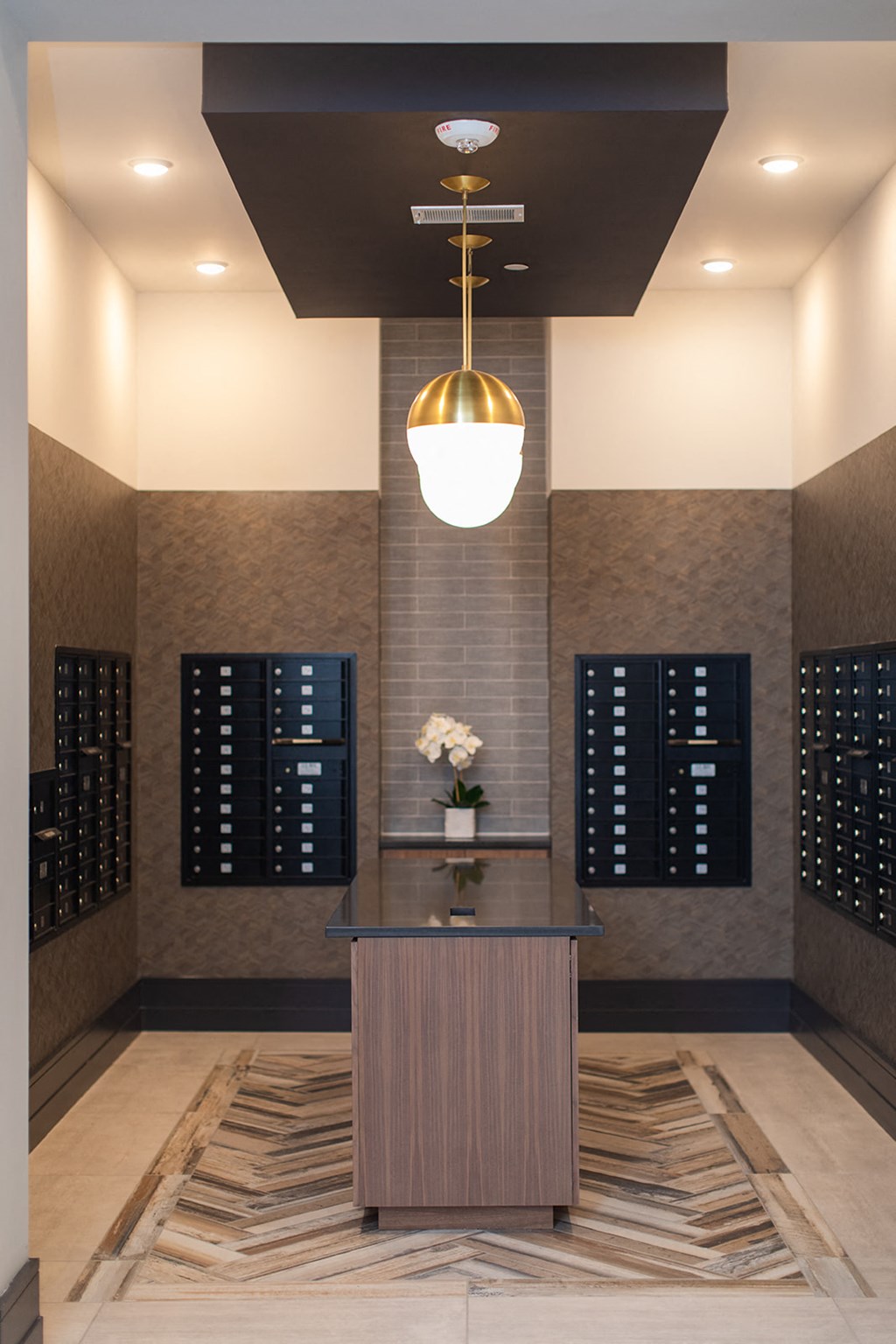 a lobby with a table and a vase of flowers at The Yards at Malvern, Malvern, PA