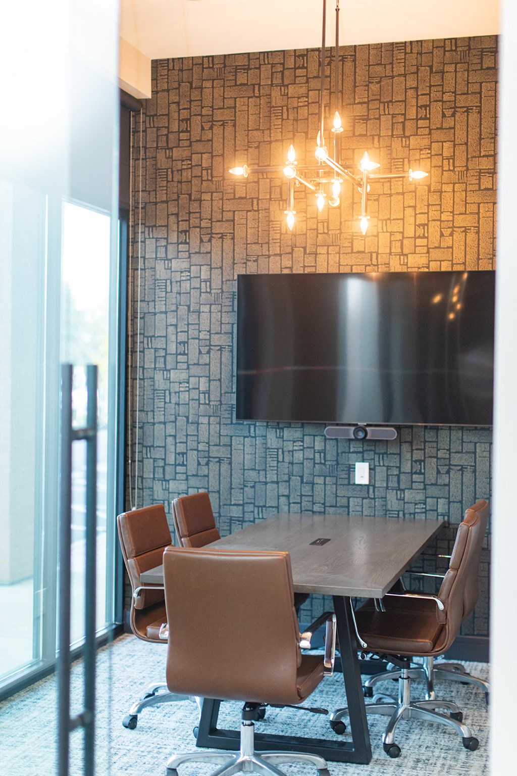 a conference room with a table and chairs and a television at The Yards at Malvern, Malvern, PA