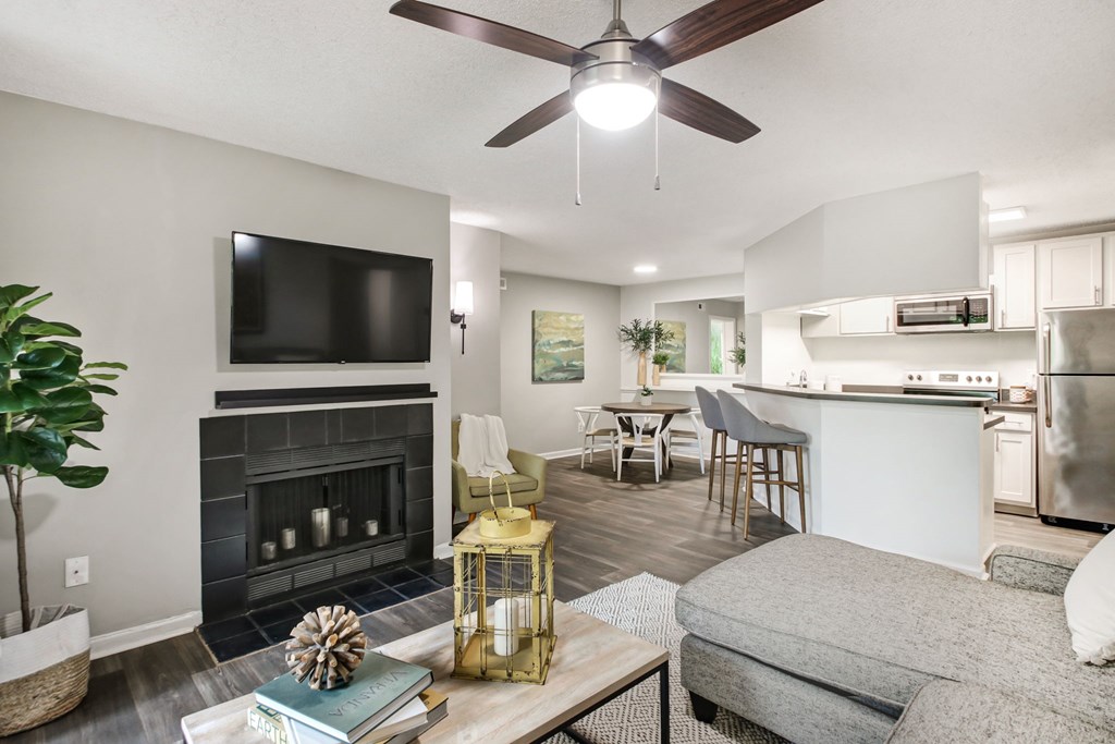 A modern living room with a fireplace and a flat screen TV.
