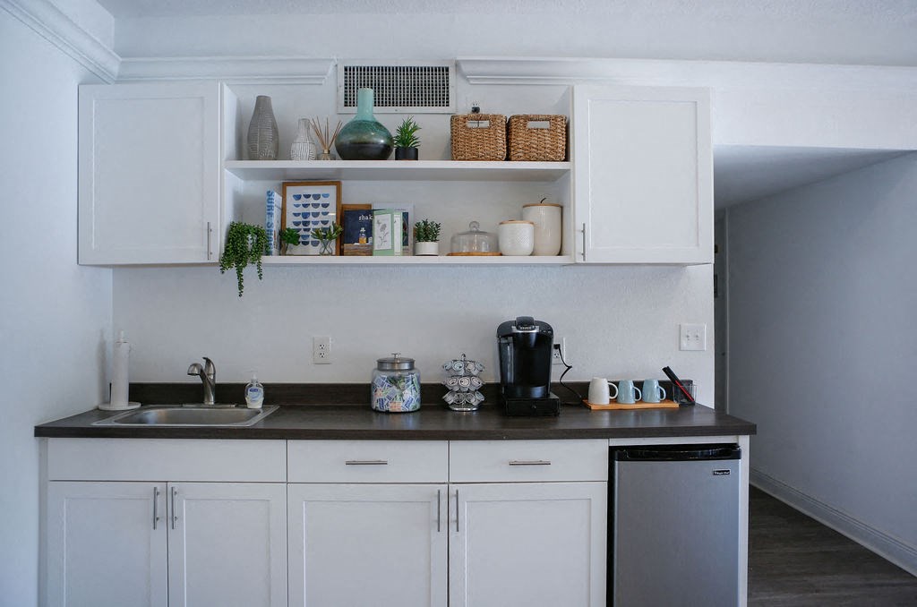 a kitchen with white cabinets and a black counter top  at The Villas at Flagler Pointe, Saint Petersburg, FL