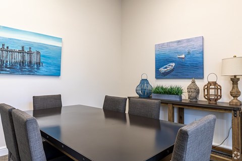 a dining room with a table and chairs and a painting on the wall at The Ledges Apartment Homes, Groton, CT, 06340