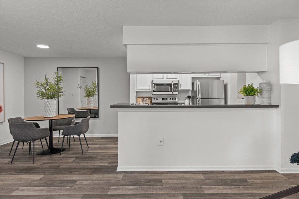 A modern kitchen with a dining table and chairs. at Eagle Ridge Apartments, Monroeville, 15146