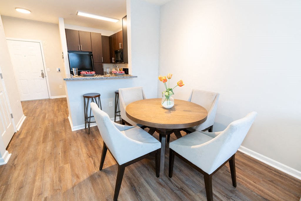 a dining room with a table and chairs at Merion Riverwalk Apartment Homes, Shelton, CT