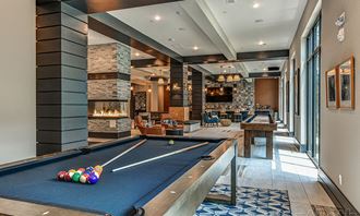 a game room with a pool table and a fireplace
