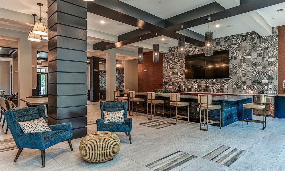 a large lobby with blue chairs and tables and a wall of wallpaper at The Yards at Malvern, Pennsylvania