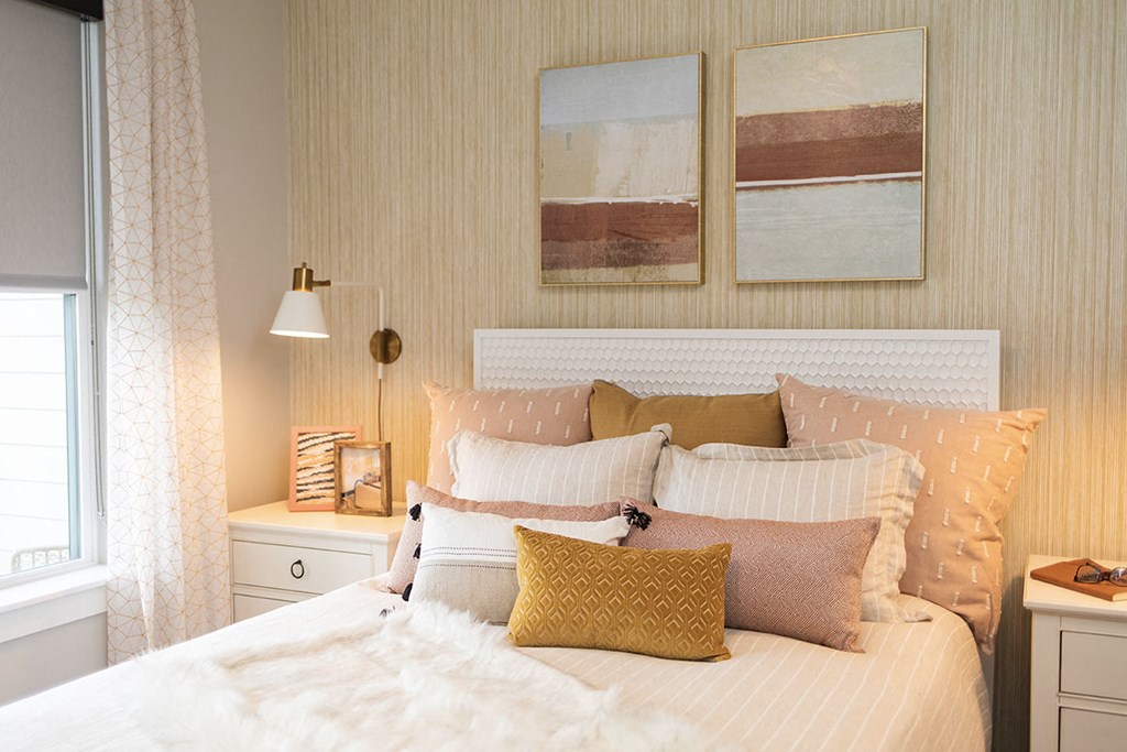 a bedroom with a bed and pillows and a window at The Yards at Malvern, Pennsylvania