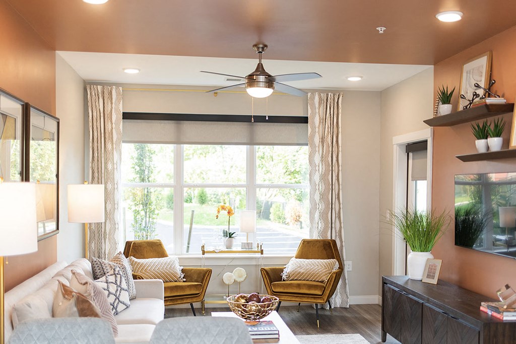 a living room with a ceiling fan and a large window at The Yards at Malvern, Malvern, Pennsylvania
