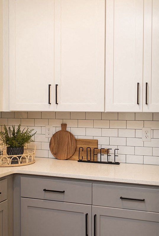 a white kitchen with white cabinets and a coffee sign at The Yards at Malvern, Malvern, PA