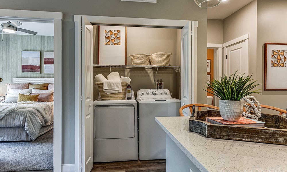 a laundry room with a washer and dryer and a closet with a bed at The Yards at Malvern, Malvern, PA