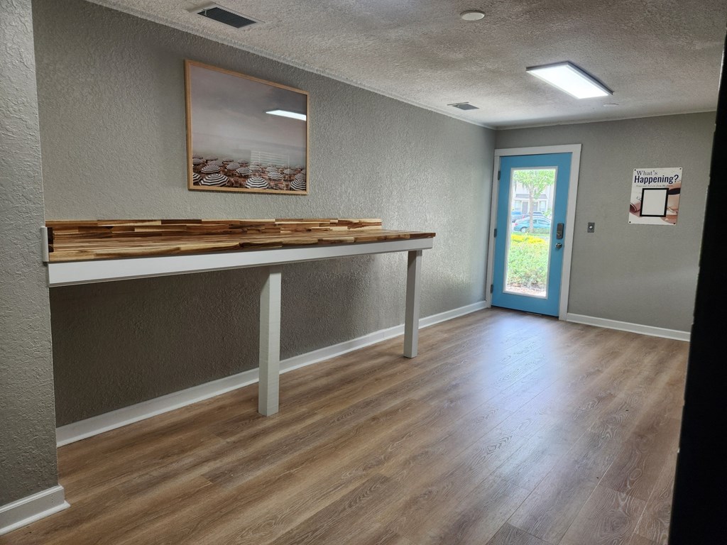 an empty room with a table in the center of it at The Fountains at Deerwood, Jacksonville, FL, 32256