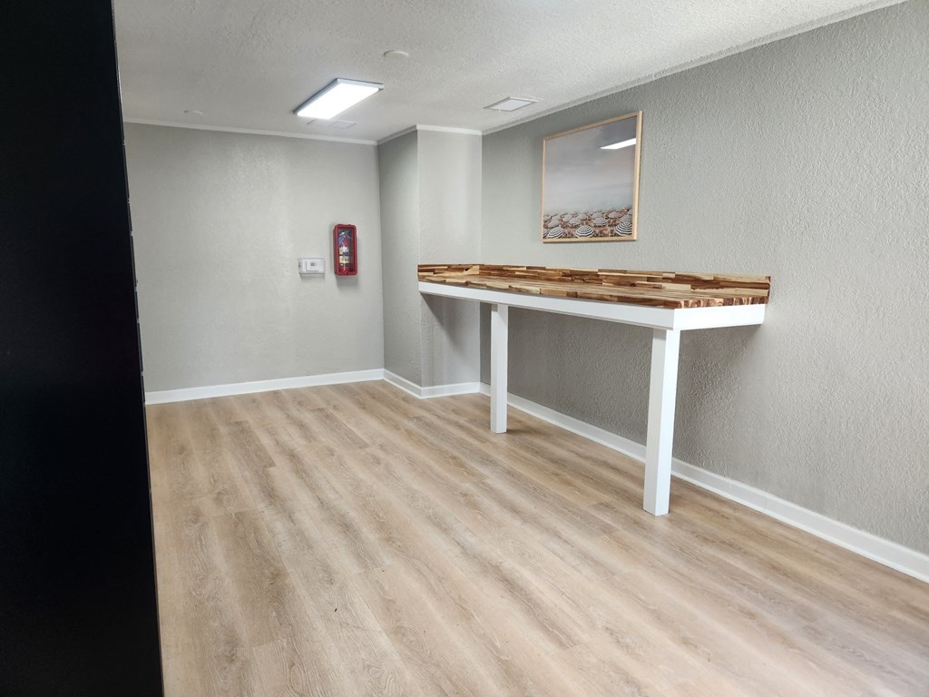 an empty room with a table in the corner at The Fountains at Deerwood, Jacksonville, FL, 32256