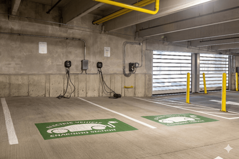 A parking garage with electric vehicle charging stations.