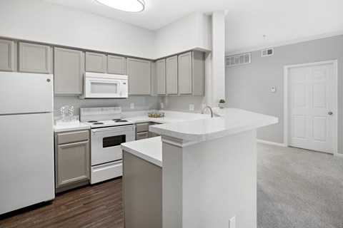 spacious bright kitchen with large countertop and bar