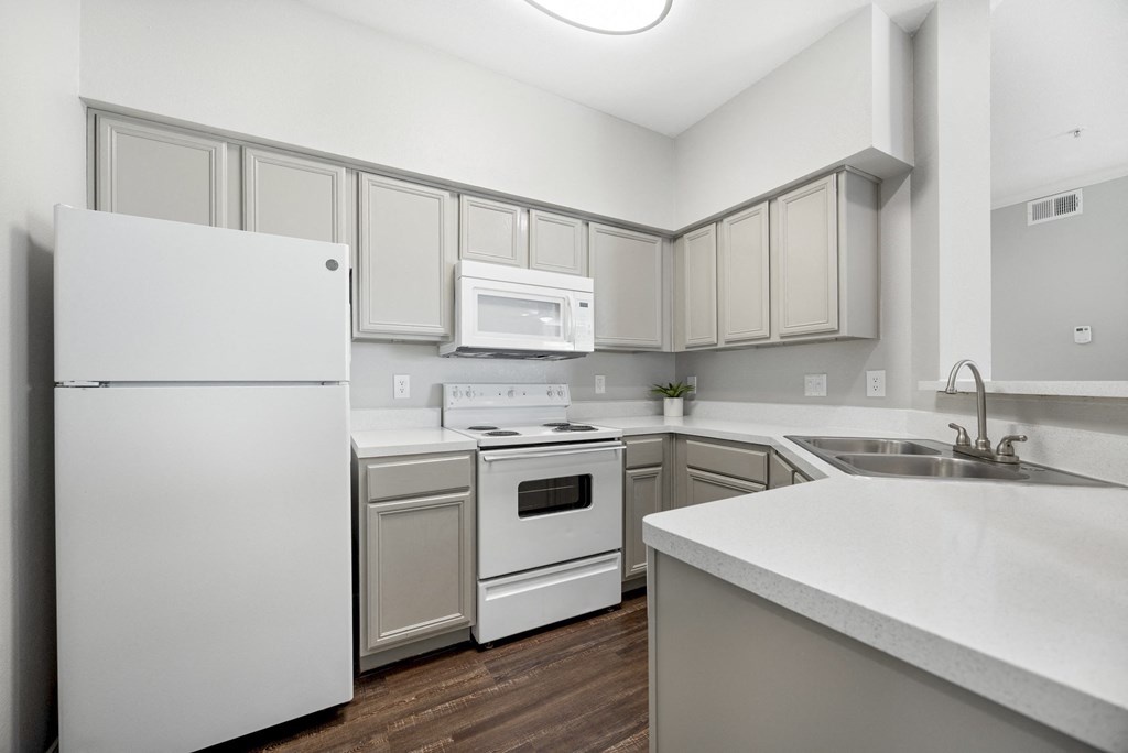 white kitchen with spacious countertop at Edgewood Village, Lewisville, TX