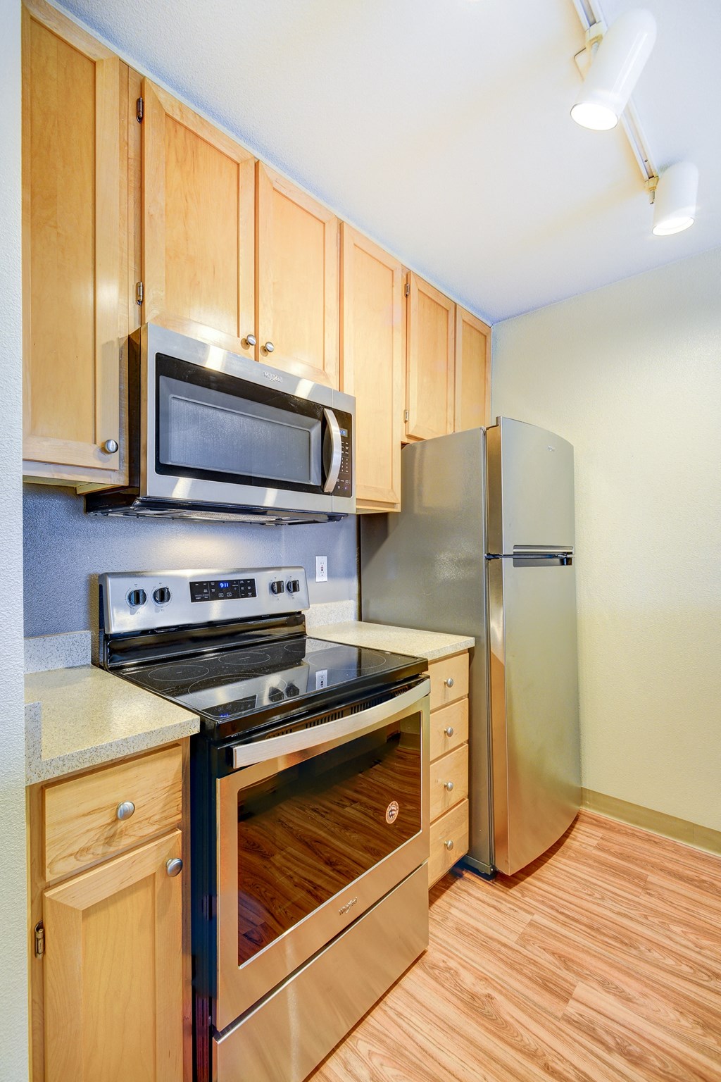 a kitchen with stainless steel appliances and wooden cabinets