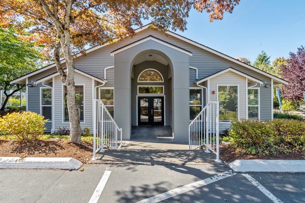 the front of a church building with stairs and a door