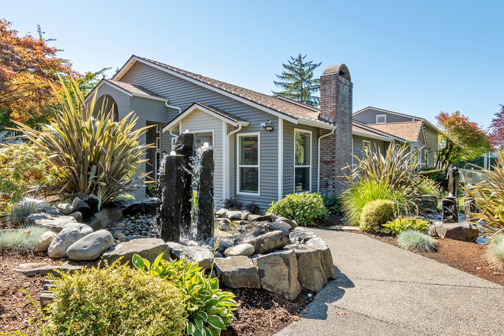 a house with a fountain in the front yard