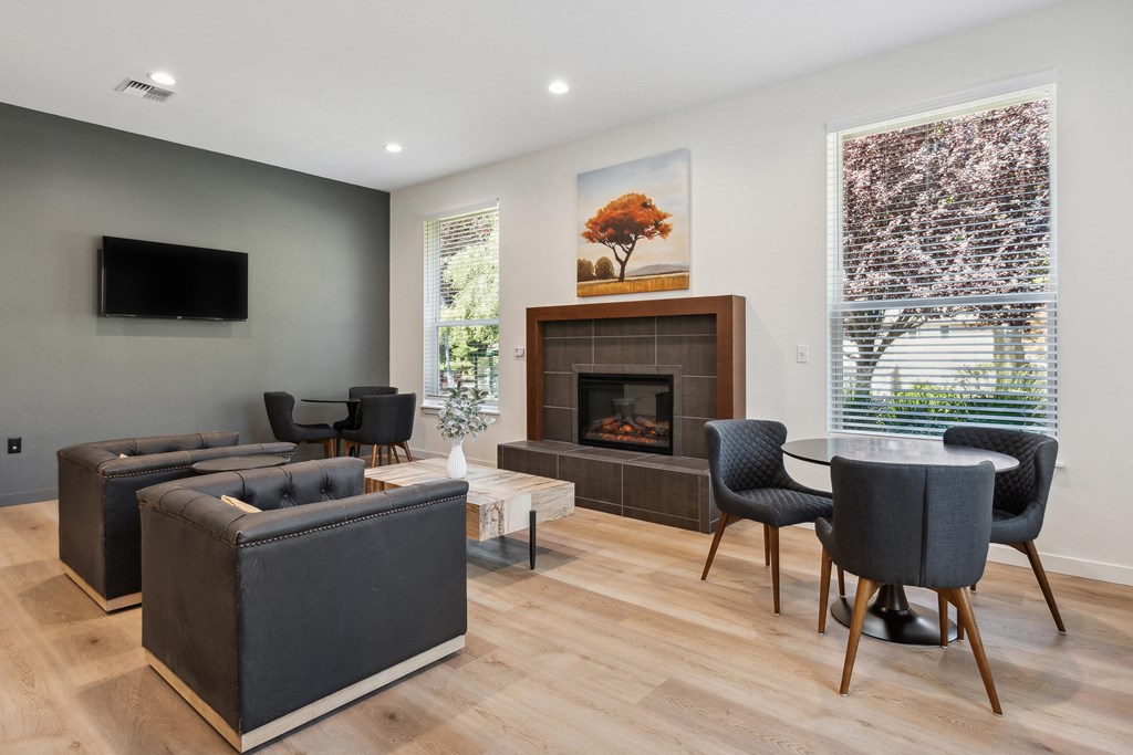 a living room with couches and chairs and a fireplace