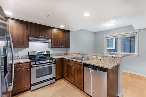 a kitchen with stainless steel appliances and granite counter tops