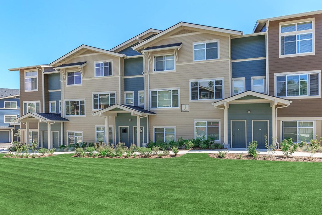 a large building with green grass in front of it
