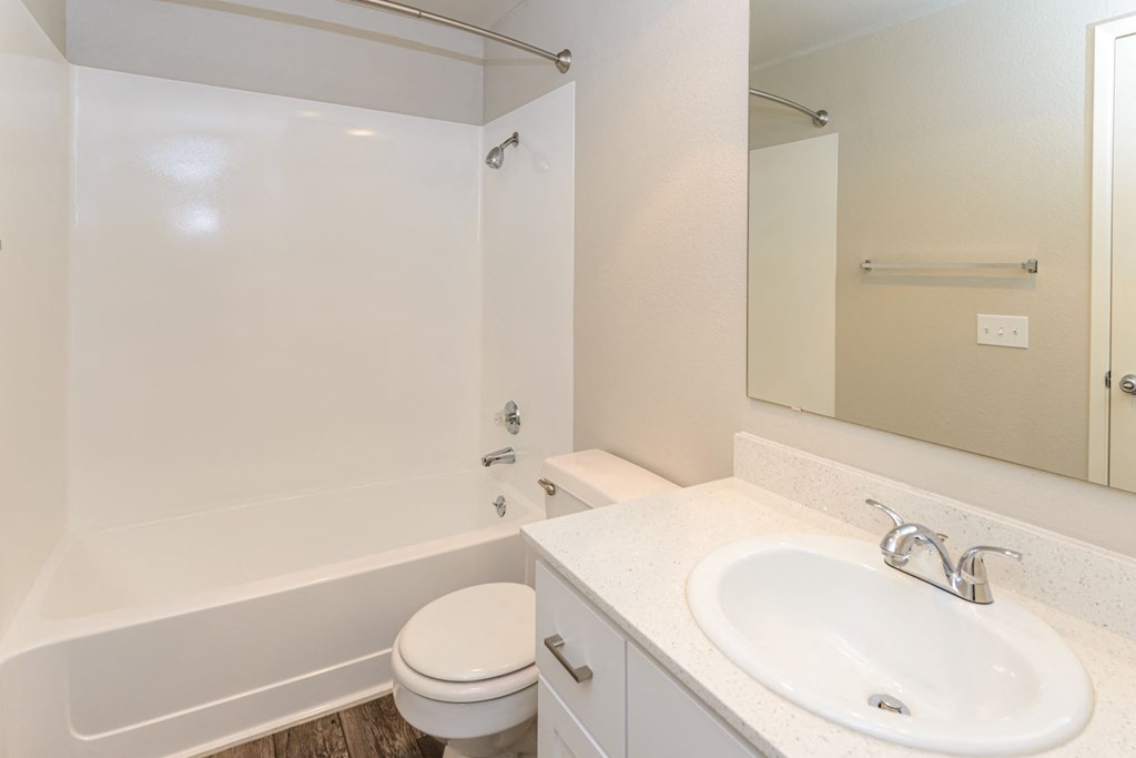 a bathroom with a sink toilet and bath tub