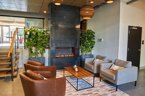 a living room with couches and chairs and a fireplace