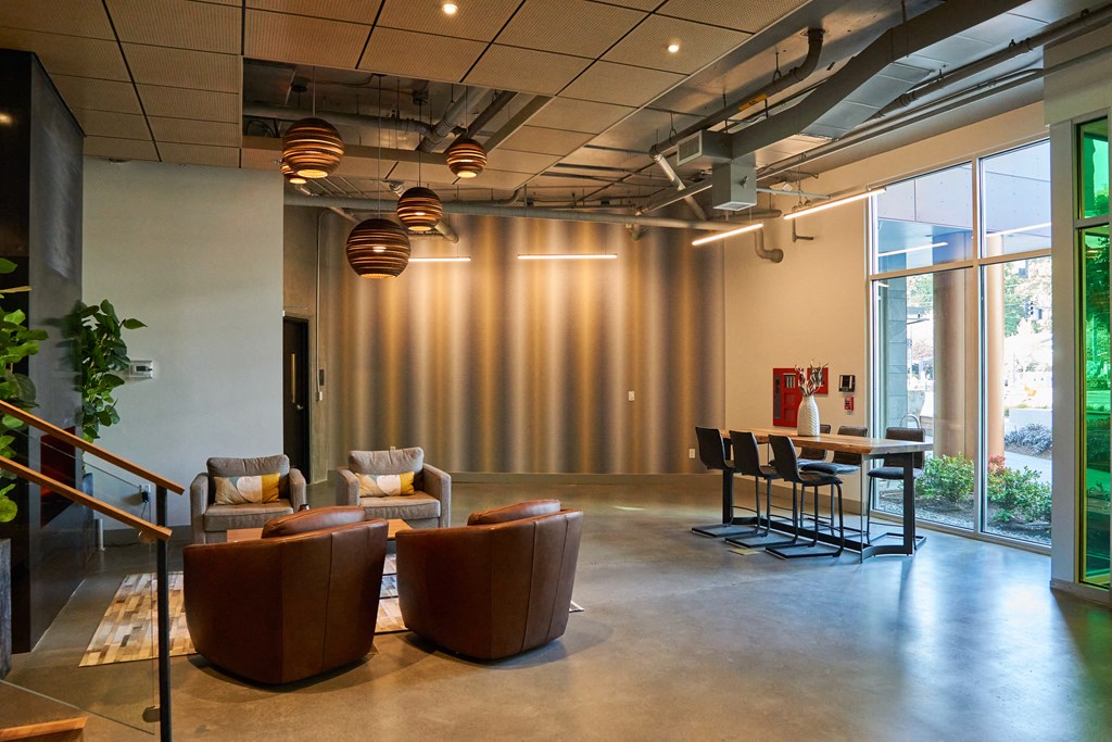 a lounge area with chairs and a table in a lobby