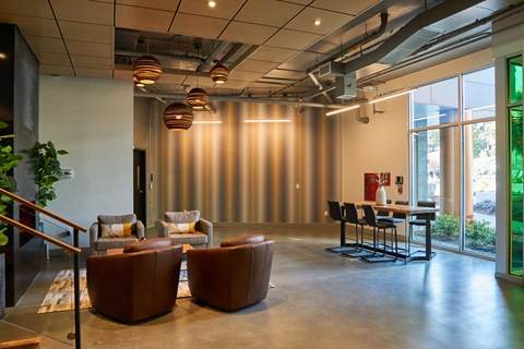 a lounge area with chairs and a table in a lobby