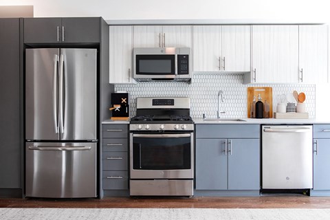 a kitchen with stainless steel appliances and white cabinets