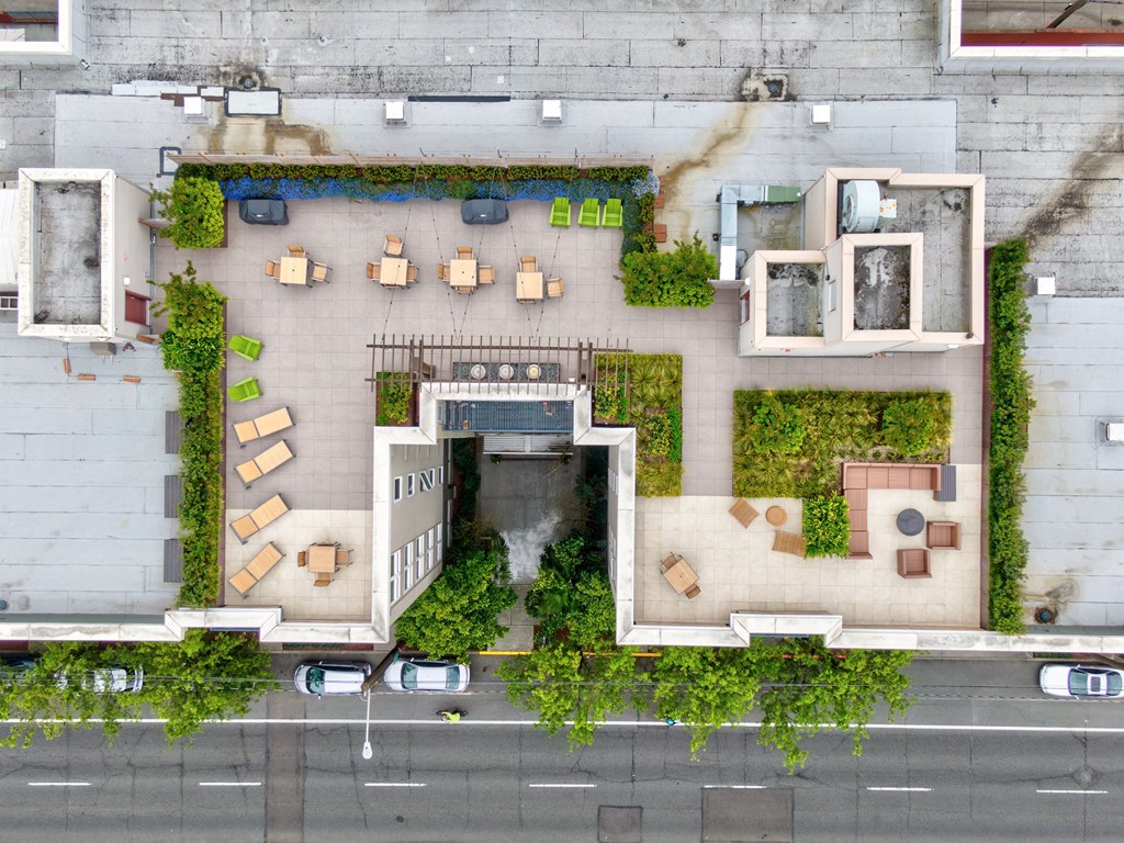 arial view of a building with greenery on the side of it